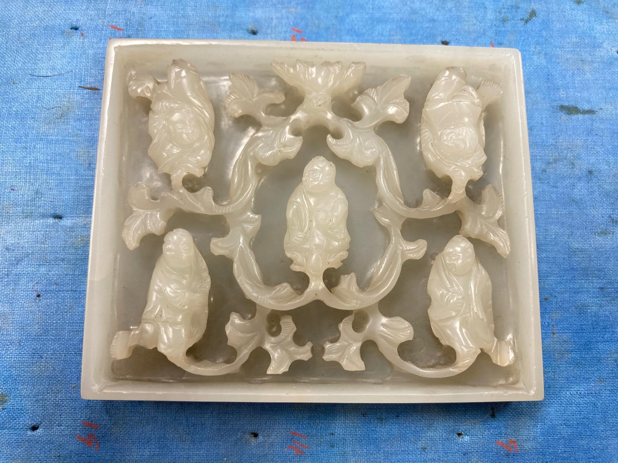 An unusual Chinese white jade plaque, 18th/19th century, 6.7cm x 8.1cm, wood stand